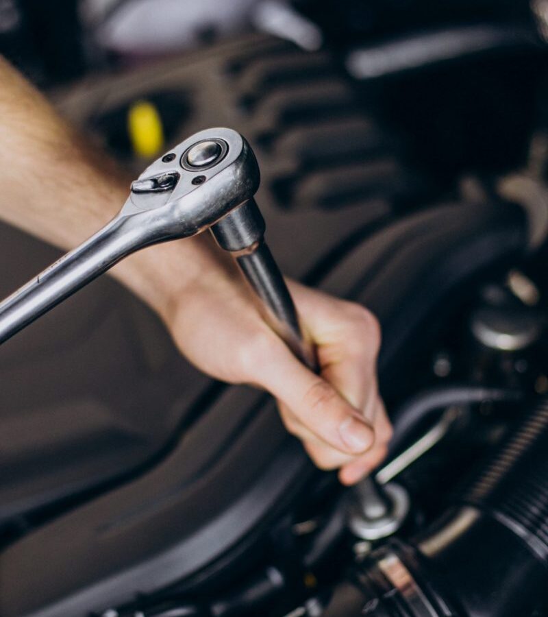repair-man-making-car-service-scaled-psg88a95dtb1mkopc0qqyqf110gkgsgre8zbyslki8